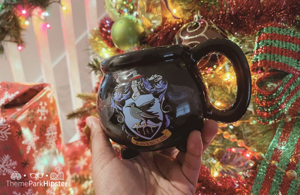 Black Harry Potter Mug in front of Christmas Tree. Keep reading to learn how to budget for the holidays and for Christmas.