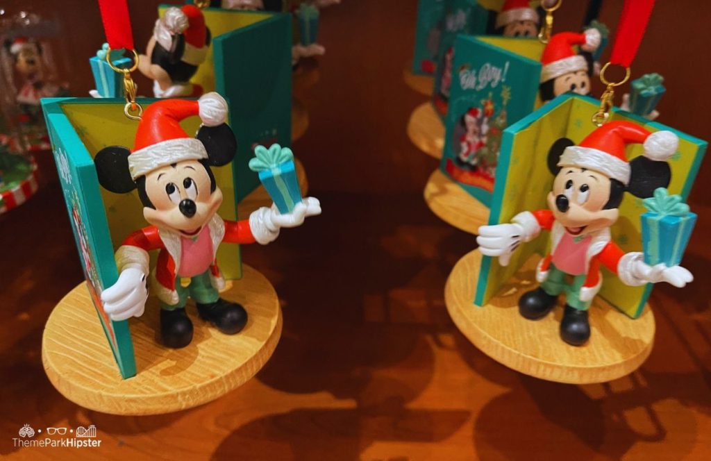 Mickey Mouse in Santa Suit coming out of a book. Keep reading to learn how to budget for the holidays and for Christmas.