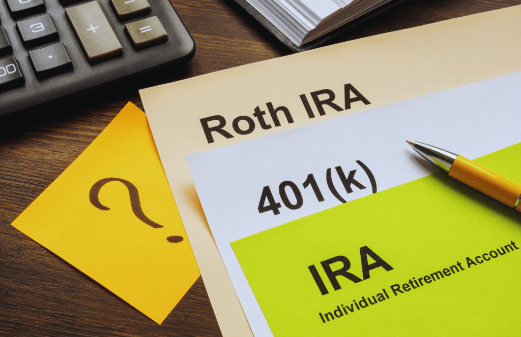 Roth IRA vs Traditional IRA vs 401k papers on a table. Money Saving Tips for Millennials