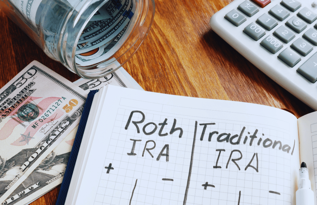 Roth IRA vs Traditional IRA with money on a desk. Money Saving Tips for Millennials